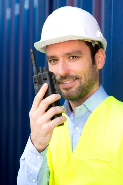 Young Attractive engineer using talkie walkie on the dock — Stock Photo, Image