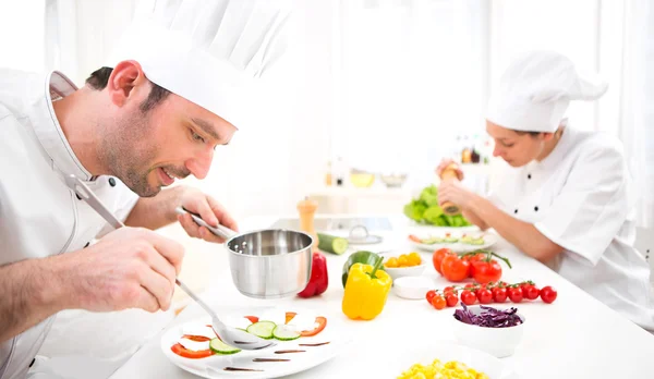 Junger attraktiver Profi-Koch kocht in seiner Küche — Stockfoto