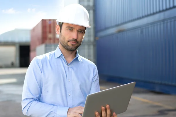 Young Attractive engineer using laptop on the dock — Stock Photo, Image