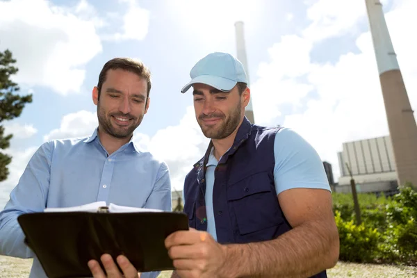 Electrician and engineer checking calendar at the electric stati — Stock Photo, Image