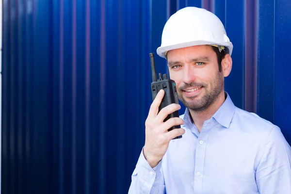 Young Attractive engineer using talkie walkie on the dock — Stock Photo, Image