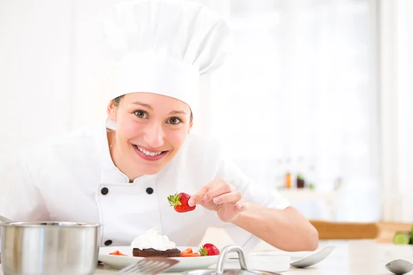 Young attractive professional chef cooking in his kitchen — Stock Photo, Image