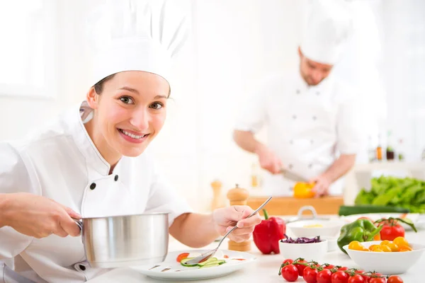 Young attractive professional chef cooking in his kitchen — Stock Photo, Image