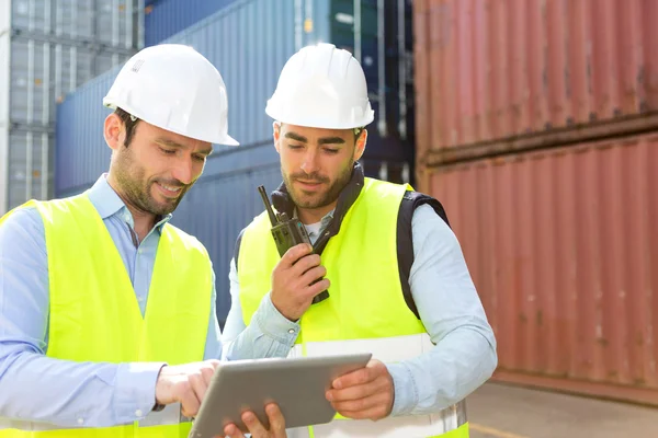 Dock worker and supervisor checking containers data on tablet — Stock Photo, Image