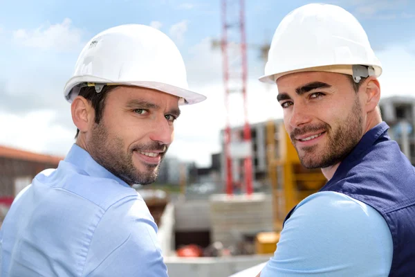 Portrait of an attractive worker and an architect on a construct — Stock Photo, Image