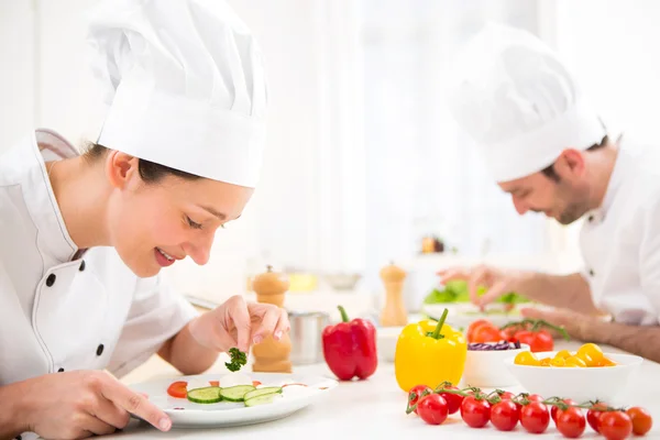 Young attractive professional chef cooking in his kitchen — Stock Photo, Image