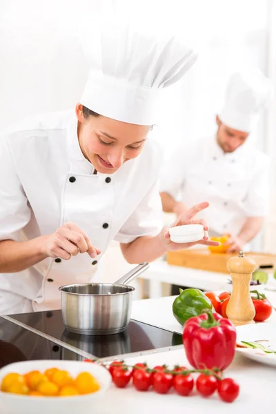 Young attractive professional chef cooking in his kitchen — Stock Photo, Image