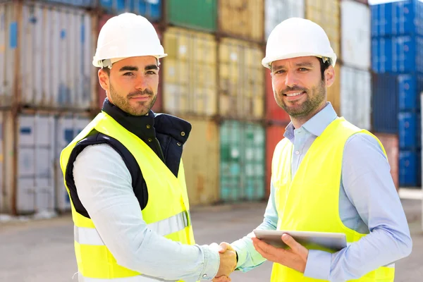 Docker and supervisor handshaking in front of containers — Stock Photo, Image