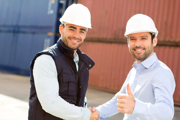 Docker and supervisor handshaking in front of containers — Stock Photo, Image