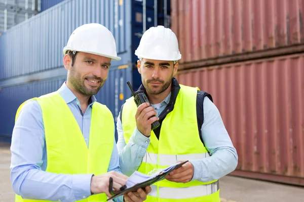 Dock worker and supervisor checking containers data on tablet — Stock Photo, Image
