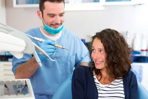 Young attractive woman being cured by a dentist — Stock Photo, Image