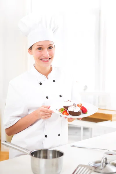 Young attractive professional chef cooking in his kitchen — Stock Photo, Image