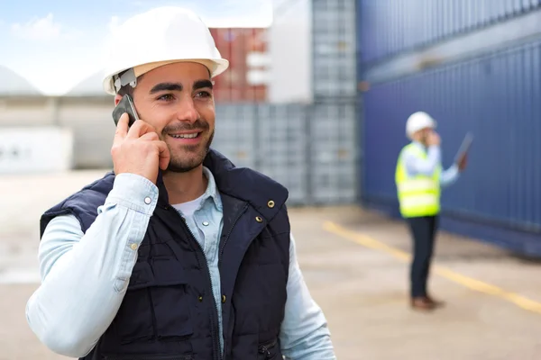 Young Attractive docker using mobile phone at work — Stock Photo, Image