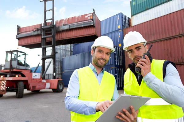 Dock worker and supervisor checking containers data — Stock Photo, Image