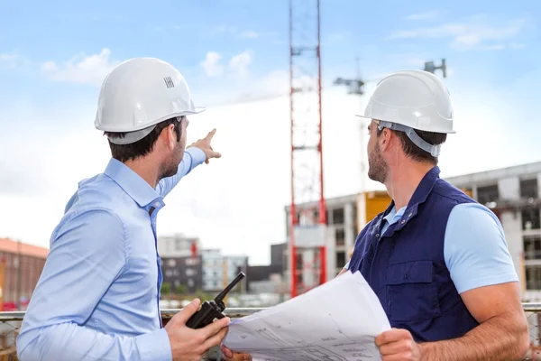 Worker and architect watching some details on a construction — Stock Photo, Image