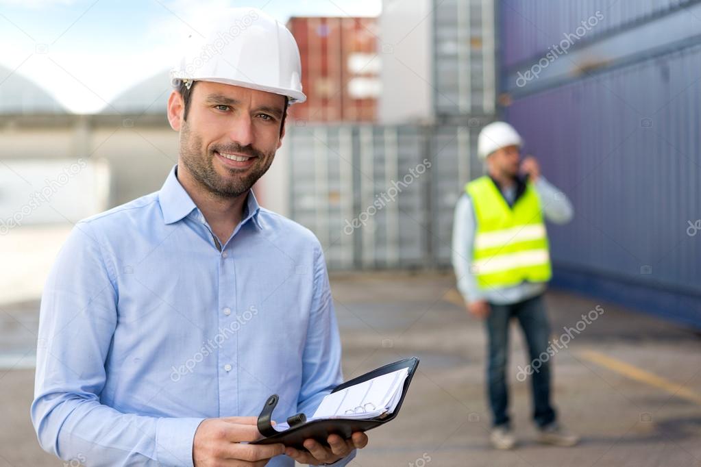 Young Attractive engineer consulting agenda on the dock