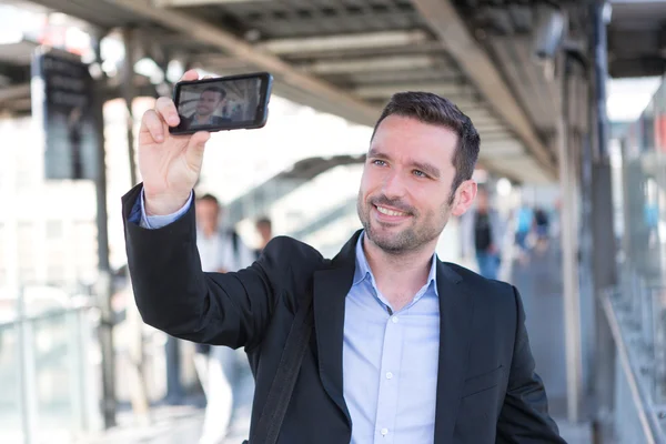 Young attractive businessman taking some selfies — Stock Photo, Image