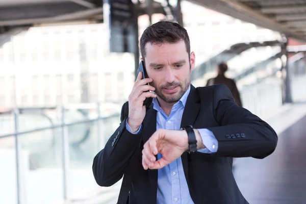 Young attractive man being late to an appointment — Stock Photo, Image