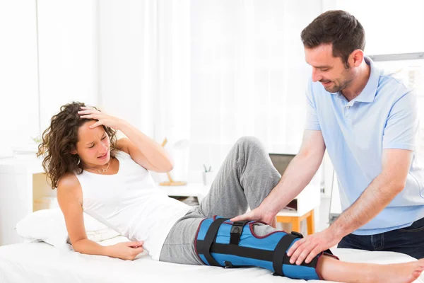 Young attractive woman being manipulated by physiotherapist — Stock Photo, Image