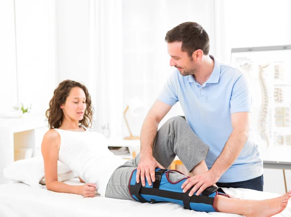 Young attractive woman being manipulated by physiotherapist — Stock Photo, Image
