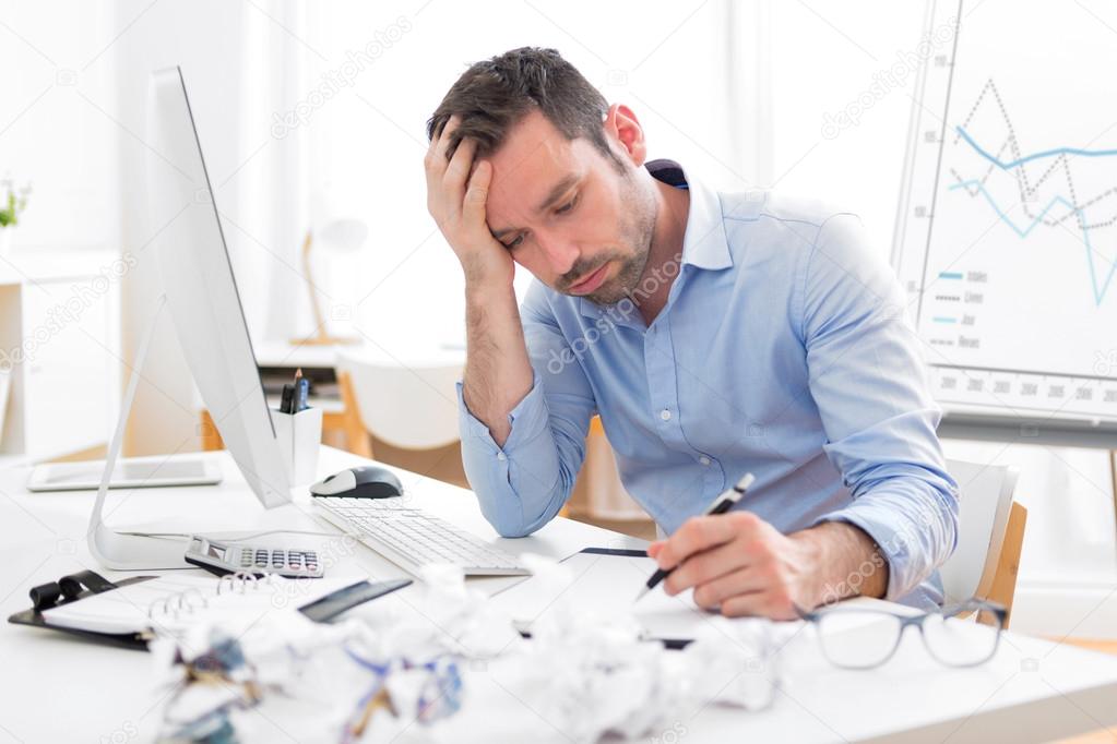 Young attractive man too tired to work