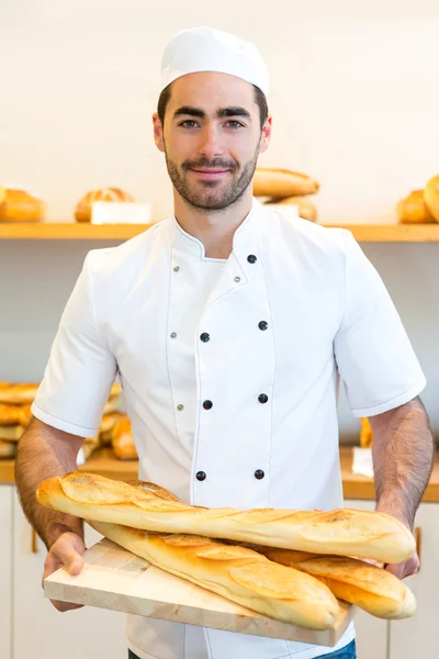 Young attarctive baker working at the bakery — Stock Photo, Image