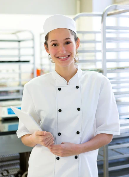 Young attarctive baker working at the bakery — Stock Photo, Image