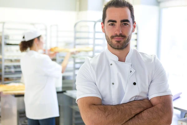 Young attarctive baker working at the bakery — Stock Photo, Image