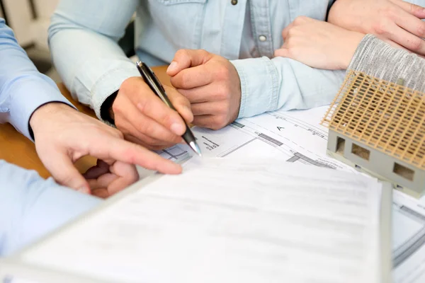 Junge attraktive Leute treffen Immobilienmakler im Büro — Stockfoto