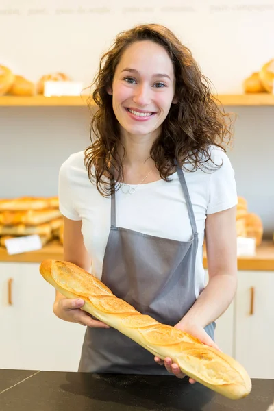 Young attarctive baker working at the bakery — Stock Photo, Image