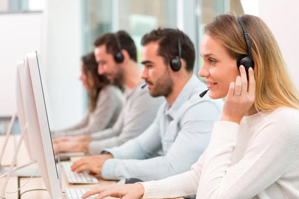 Young attractive woman working in a call center — Stock Photo, Image