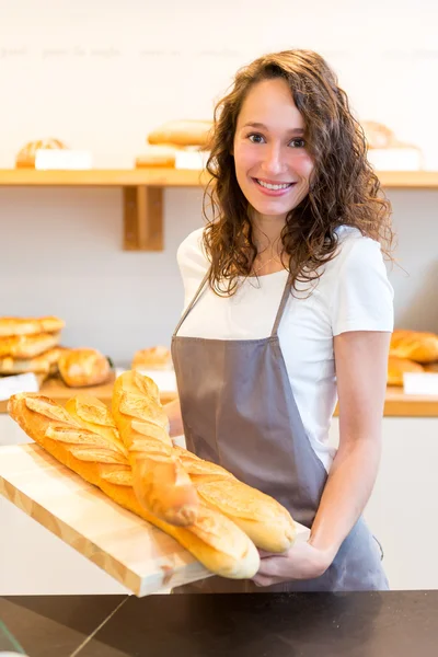 Young attarctive baker working at the bakery — Stock Photo, Image