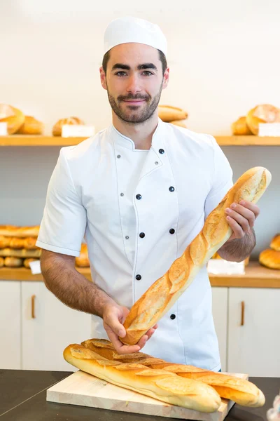 Young attarctive baker working at the bakery — Stock Photo, Image