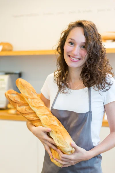 Young attarctive baker working at the bakery — Stock Photo, Image