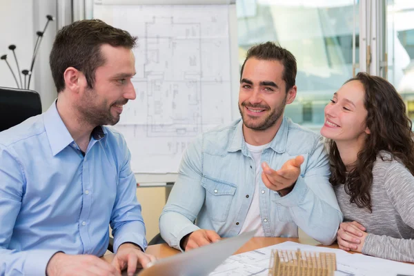 Junge attraktive Leute treffen Immobilienmakler im Büro — Stockfoto