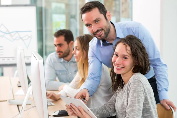 Young attractive people taking a training course with formator — Stock Photo, Image