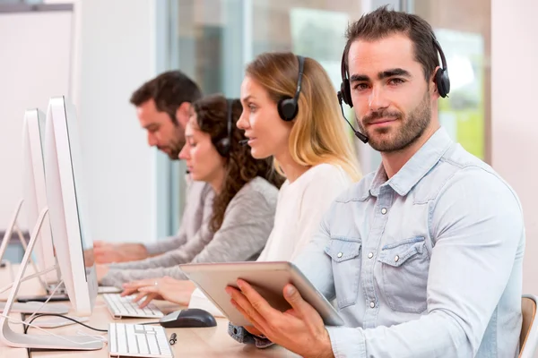 Young attractive man working in a call center — Stock Photo, Image