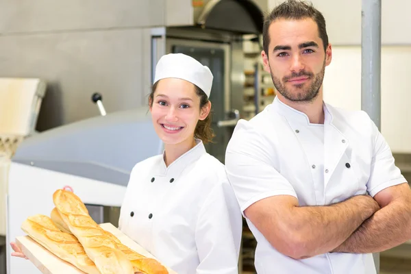 Team of bakers working at the bakery — Stock Photo, Image