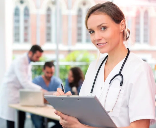 Portrait of a young attractive doctor at the hospital — Stock Photo, Image