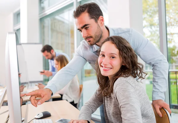 Young attractive people taking a training course with formator — Stock Photo, Image