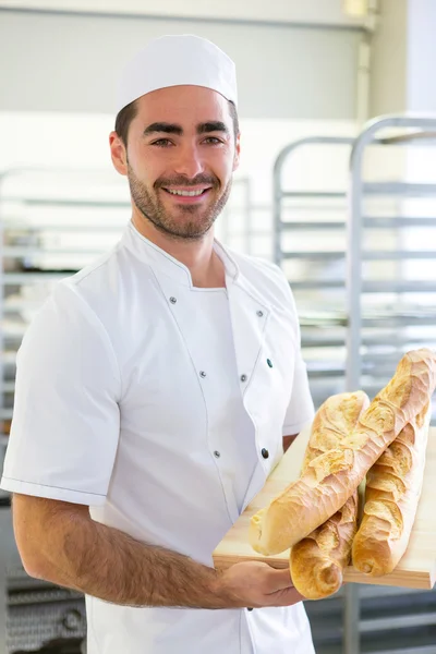 Young attarctive baker working at the bakery — Stock Photo, Image
