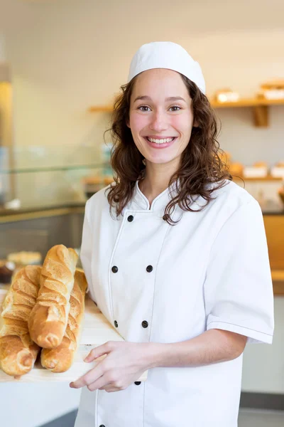 Young attarctive baker working at the bakery — Stock Photo, Image