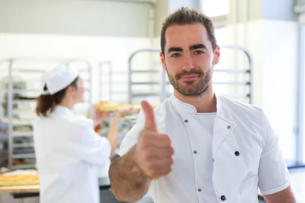 Young attarctive baker working at the bakery — Stock Photo, Image