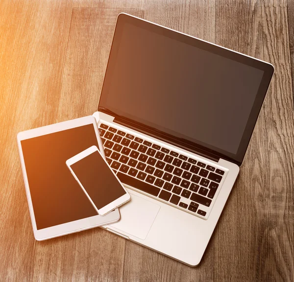 Laptop in high definition with tablet and mobile phone on a wood — Stock Photo, Image