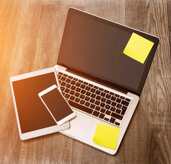 Laptop in high definition with tablet and mobile phone on a wood — Stock Photo, Image