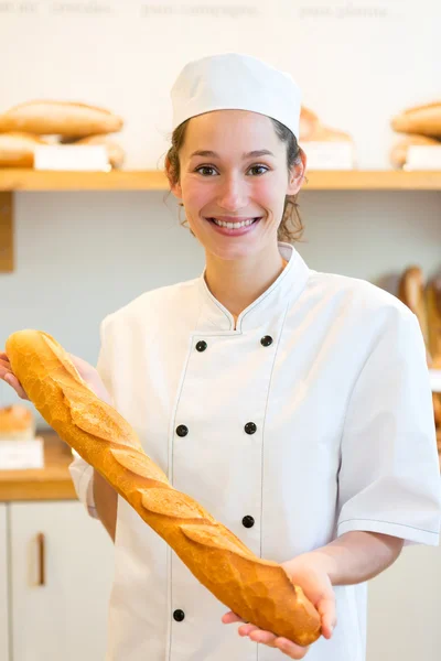 Young attarctive baker working at the bakery — Stock Photo, Image