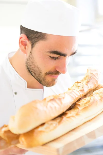 Young attarctive baker working at the bakery — Stock Photo, Image