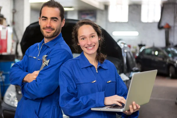 Equipe de mecânicos que trabalham na garagem — Fotografia de Stock