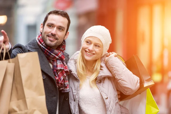 Jonge aantrekkelijke paar met shopping tassen — Stockfoto