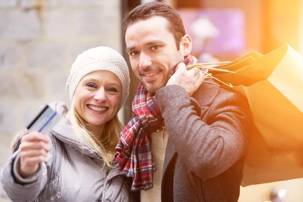 Young attractive couple with shopping bags — Stock Photo, Image